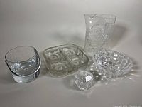 Full lot with Skruf divided dish, Orrefors bubble bowl, Tiffany & Co. vanity box, Riedel crystal pitcher, and small ice bucket visible on white background.