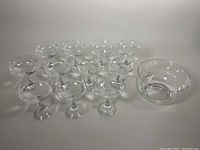 Full set of eleven glasses arranged with serving bowl at right