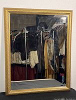 Front view of the rectangular mirror with gilded frame and beveled glass, showing its size and general condition.