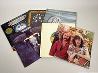 Photo showing a collection of vintage vinyl albums from several classic rock and soft rock artists including Crosby & Nash, Seals & Crofts, Chicago, Eagles, Bee Gees, Roberta Flack.