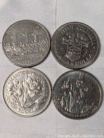 Four Canadian dollar coins including 1987 Confederation Constitution coin, 1981 British Columbia coin, 1970 Manitoba Centennial coin, and a floral design coin, all in very good condition.