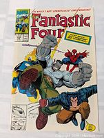 Front cover of the 1991 Marvel Comics Fantastic Four issue 348, showing dynamic action scene with Spider-Man and Fantastic Four characters.