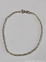 Full view of the sterling silver bracelet showing unique linked chain and spring ring clasp.