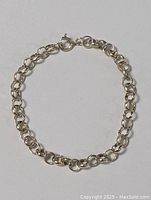 Full view of the sterling silver bracelet arranged in a circular shape on a white background.