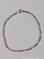 Full view of the circular sterling silver link bracelet showing chain style and clasp.