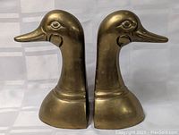 Front and side view showing the pair of brass duck head bookends.