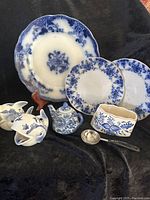 Overview of all items including plates, whale figurines, cream pitcher, spoon rest, and spoon.