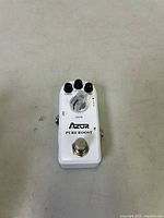 Front view of white Azur Pure Boost guitar effect pedal showing control knobs for bass, level, treble, gain, and footswitch