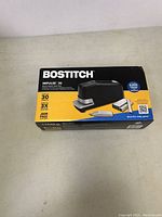 Box of Bostitch Impulse 30 electric stapler on a surface, showing front and top graphics and specification details.