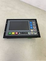 Front view of DDCSv3.1 CNC controller unit showing LCD screen and labeled function buttons.