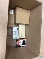 Box containing multiple small boxed items with partial labels