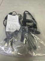 LED grow light with black flexible lamp arms and power cords in plastic packaging, user manual visible.