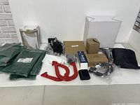 Wide view of entire lot showing all items on a white table against a wall