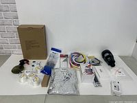 Overall shot of lot showing all included items on white surface against white wall.