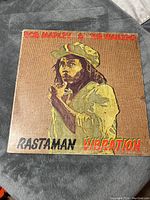 Front cover of 'Rastaman Vibration' vinyl album showing Bob Marley illustration and text.