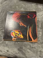 Front cover of the Electric Light Orchestra Discovery vinyl album showing the man with a red turban holding a glowing object.