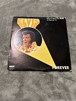 Front view of Elvis Forever 2 record set album cover with yellow and white graphic and photo of Elvis Presley.