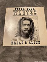 Front cover of the Peter Tosh 'Wanted Dread & Alive' LP showing the artist's photo and album title.
