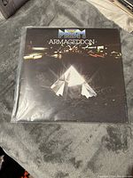 Front cover of Prism 'Armageddon' LP record showing night cityscape and prism image.