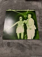 Front cover of the vinyl LP album 'Sneakin' Sally Through the Alley' by Robert Palmer, showing two people dancing in a green tint.
