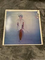 Front cover of Sparks LP "Number 1 In Heaven" featuring a person in white outfit and styled hair on plain background.