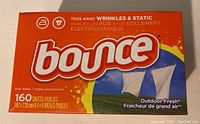 Front of unopened orange Bounce dryer sheets box showing branding, scent, and sheet count.