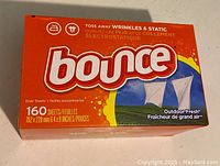 Front side of the unopened Bounce Dryer Sheets box with branding, scent, and number of sheets visible.