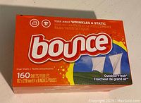 Front view of unopened Bounce Dryer Sheets box showing branding, sheet count, size, and scent.