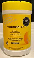 Front view of the unopened cylindrical container of watera&co. disinfectant wipes with yellow lid and label showing product details.