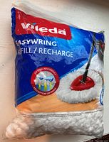 Front view of the unopened Vileda EasyWring mop head refill package showing brand and product image.