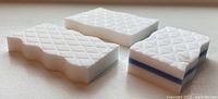 Photo of three eraser sponges showing different sizes and textured patterns