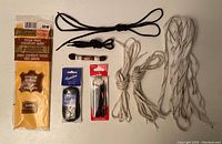 Photo of shoelaces and leather insole showing the full set including black, brown, and white shoelaces plus the packaged insole.