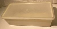 Photo of vintage large rectangular Tupperware container with fitted lid, opaque white plastic