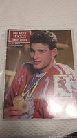 Front cover of Beckett Hockey Monthly magazine June 1991 featuring a hockey player in a red and white jersey with medals, inside protective plastic sleeve.