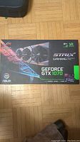 Front of Asus ROG Strix GeForce GTX 1070 box showing branding and gaming features