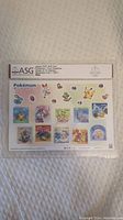 Full view of the graded sheet of 10 Pokemon Four Seasons stamps with grading label at the top