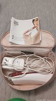 Silk'n FaceFX anti-aging device in carrying case with charger and user instructions.
