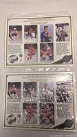 Two Upper Deck commemorative hockey sheets side by side, showing six player images and descriptions on each sheet inside a protective sleeve.