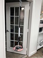 Full view of baby bouncer hanging from a door frame.