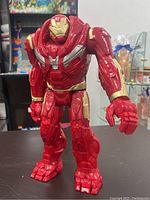 Front view of the large red and gold Ironman Hulkbuster figurine standing on a table.