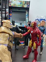 Photo showing Thanos shaking hands with Iron Man, Black Panther and other Marvel characters in the background