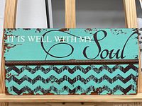 Full view of the wooden wall art sign with text and chevron pattern.