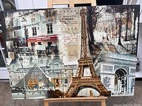 Front view of canvas art showing Eiffel Tower, Louvre Pyramid, Arc de Triomphe, and Parisian street scenes.