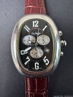 Front view of La Swiss men's quartz chronograph watch with black dial, white numerals, three sub-dials, and red leather strap on black background.