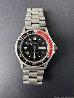 Full view of the Sensor dive watch with black and red bezel, stainless steel bracelet, black dial with luminescent hands and markers, day and date indicator at 3 o'clock, tachymeter scale, showing condition and overall appearance.