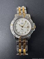 Front view of vintage Esquire ESQ dive watch showing silver dial, gold-tone accents, date window, and two-tone bracelet.