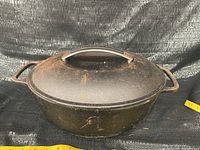 Overall front view of the KitchenAid cast iron Dutch oven showing surface condition and size.