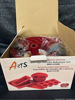 Boxed set of Arts 5 piece silicone bakeware set with visible red molds inside, sealed in plastic.