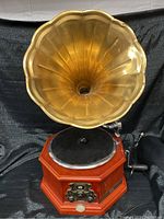 Full view of the Victrola style audio system showing large metal horn and wood veneered base