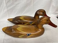 Two wooden duck decoys displayed side by side showing overall shape and paint detail